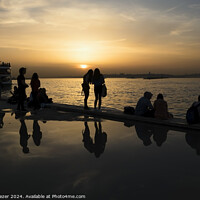 Buy canvas prints of Silhouettes of some young people with beautiful reflections on the water at sunset by Engin Sezer