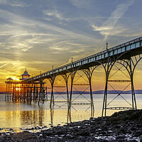 Buy canvas prints of Clevedon Pier on a bright evening with colourful reflections by Rory Hailes
