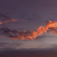 Buy canvas prints of The setting sun lighting up a cloud by Rory Hailes
