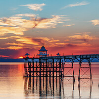 Buy canvas prints of Clevedon Pier at sunset with colourful reflection on the sea by Rory Hailes
