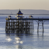 Buy canvas prints of Clevedon Pier with sunlight reflecting onto the sea by Rory Hailes
