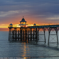 Buy canvas prints of Clevedon Pier at sunset with a reddish orangey glow in the background by Rory Hailes