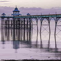 Buy canvas prints of Clevedon Pier with its leg reflecting onto a calm sea by Rory Hailes