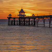 Buy canvas prints of Clevedon pier at sunset with a reddish orangey glow by Rory Hailes