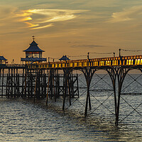 Buy canvas prints of Clevedon Pier at sunset and sunlight reflecting onto the side panels by Rory Hailes