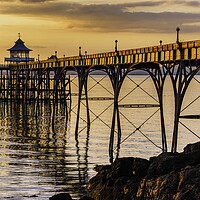 Buy canvas prints of Clevedon Pier at Sunset sunlight reflecting onto the sea by Rory Hailes