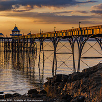 Buy canvas prints of Clevedon Pier at Sunset with the pier side panels catching the sunlight by Rory Hailes