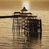 Buy canvas prints of Clevedon Pier at sunset with a calm and tranquil sea by Rory Hailes