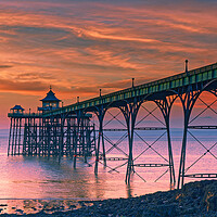 Buy canvas prints of Clevedon Pier at sunset on a calm evening with cloud and blue sky above by Rory Hailes