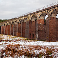 Buy canvas prints of A snow covered landscape at the old railway viaduct at the Big Water of Fleet by SnapT Photography