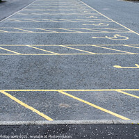 Buy canvas prints of Numerous empty yellow marked disable vehicle parking spaces in a car park by SnapT Photography