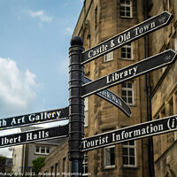 Buy canvas prints of Sign post highlighting the directions to attractions in stirling town centre by SnapT Photography