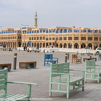 Buy canvas prints of Green and blue coloured benches in rows in Souq Waqif Square, Doha, Qatar by SnapT Photography