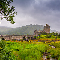 Buy canvas prints of Looking out to Eilean Donan Castle, where three sea lochs meet, Loch Duich, Loch Long and Loch Alsh, on an overcast day in the Sco by SnapT Photography