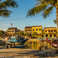 Buy canvas prints of A view across the river from the south bank in Hoi An Vietnam, by SnapT Photography