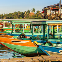Buy canvas prints of Colorful Vietnamese traditional boats, moored on the harbour wall, Hoi An, Vietnam - January 10th, 2015 by SnapT Photography
