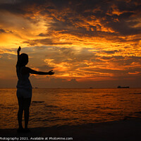 Buy canvas prints of A female model silhouette controlling the movements of clouds on Ba Keo Beach by SnapT Photography