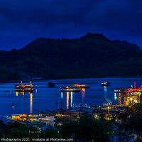 Buy canvas prints of A view over the harbour at Labuan Bajo and nearby island at night by SnapT Photography