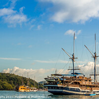 Buy canvas prints of Large yachts in Labuan Bajo harbour in morning by SnapT Photography