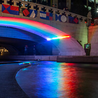 Buy canvas prints of A rainbow reflecting on the Cheonggyecheon Stream at Gwangtonggyo Bridge by SnapT Photography
