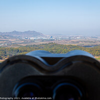 Buy canvas prints of A view into North Korea across the DMZ from South Korea, from behind binoculars by SnapT Photography