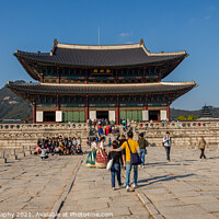 Buy canvas prints of Tourists at the entrance to Gyeongbokgung Palace on a fall day in Seoul by SnapT Photography