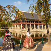 Buy canvas prints of Women dressed in hanbok traditional dresses by the lake at Gyeongbokgung Palace by SnapT Photography