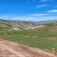 Buy canvas prints of Dirt track leading up a Mongolian grassland valley on a summer day by SnapT Photography