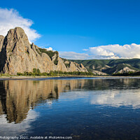 Buy canvas prints of A mountain reflecting on the Delger Murun River in Mongolia in the evening sun by SnapT Photography