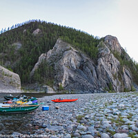 Buy canvas prints of Fishing rafts and kayaks on a gravel bank on a Mongolian river canyon by SnapT Photography