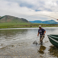 Buy canvas prints of A fisherman with a Taimen Trout on the end of his line in Mongolia, Moron, Mongolia - July 14th 2014 by SnapT Photography