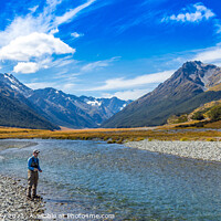 Buy canvas prints of An Angler fly fishing for trout on the Ahuriri river, surrounded by mountains by SnapT Photography