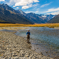 Buy canvas prints of An Angler fly fishing for trout on the Ahuriri river, surrounded by mountains by SnapT Photography