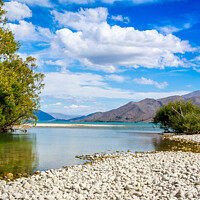 Buy canvas prints of The slow flowing Pukaki river as it flows into Lake Benmore on a sunny day by SnapT Photography
