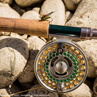 Buy canvas prints of A close up of a trout fly rod, reel and line on rocks, with a cicada fly by SnapT Photography