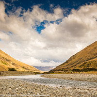Buy canvas prints of A New Zealand mountain stream in a V shaped valley with dramatic clouds by SnapT Photography