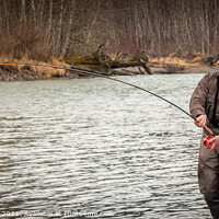 Buy canvas prints of A fly fisherman hooked into a big fish in a river with the rod bent by SnapT Photography