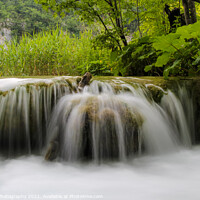 Buy canvas prints of Long exposure of water flowing over a small waterfall at Plivice Lakes, Croatia by SnapT Photography