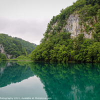 Buy canvas prints of A reflection of a mountain valley on a lake at Plitvice Lakes, Croatia by SnapT Photography