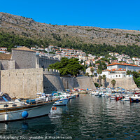 Buy canvas prints of Boats moored in Dubrovnik Harbour by the city walls of the old town, Croatia by SnapT Photography