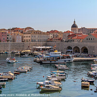 Buy canvas prints of A view over the old harbour and town with boats and yachts moored, Dubrovnik by SnapT Photography