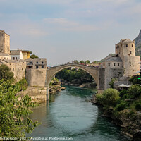 Buy canvas prints of A landscape view of the old town of Mostar, with the old bridge over the river by SnapT Photography