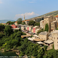 Buy canvas prints of The old town of Mostar looking upstream from the historic old arched bridge by SnapT Photography