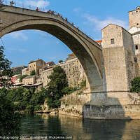Buy canvas prints of Close up of the historic arched Old Bridge of Mostar on the Neretva River by SnapT Photography