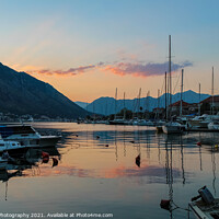 Buy canvas prints of Boats moored in Kotor harbour at sunset, by the old town, Montenegro by SnapT Photography
