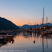 Buy canvas prints of Sunset reflecting over the harbour of the Old Town of Kotor, Montenegro by SnapT Photography