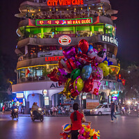 Buy canvas prints of A lone balloon sellar at Dong Kinh Nghia Thuc Square, Hanoi, Vietnam. by SnapT Photography