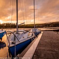 Buy canvas prints of Yachts moored at Kirkcudbright marina at sunset in winter on the Dee estuary by SnapT Photography