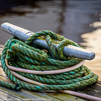 Buy canvas prints of Rope tied around a metal bollard mooring on a wooden jetty by SnapT Photography