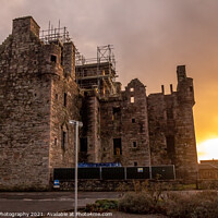 Buy canvas prints of MacLellan's Castle at sunset on the old High Street in Kirkcudbright, Scotland by SnapT Photography